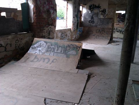 Two more plywood quarterpipes form a little run, everything here is covered in toy graffiti.